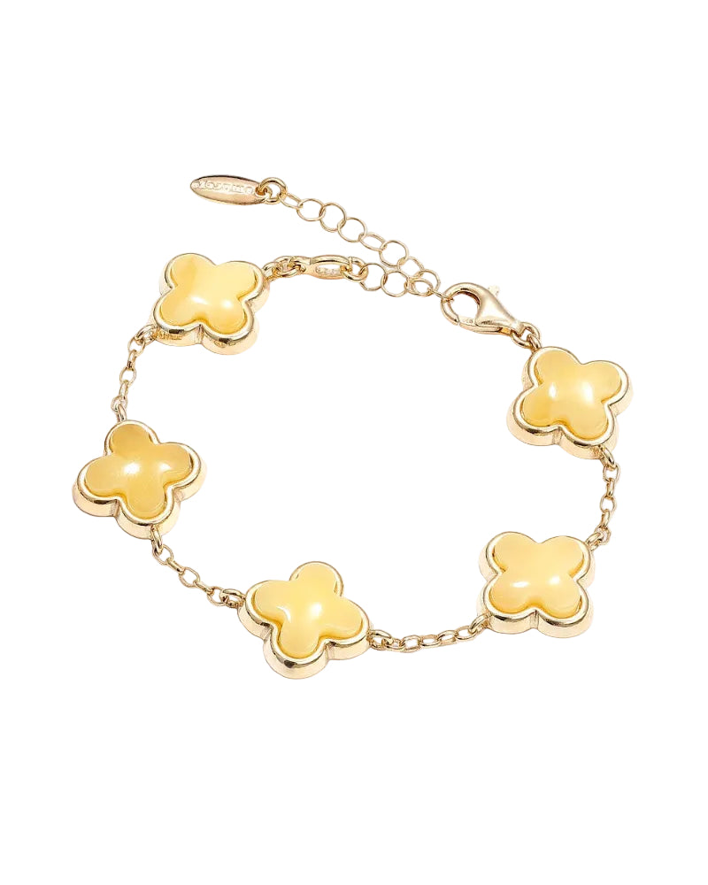 Gold bracelet with yellow clover-shaped links on a white background