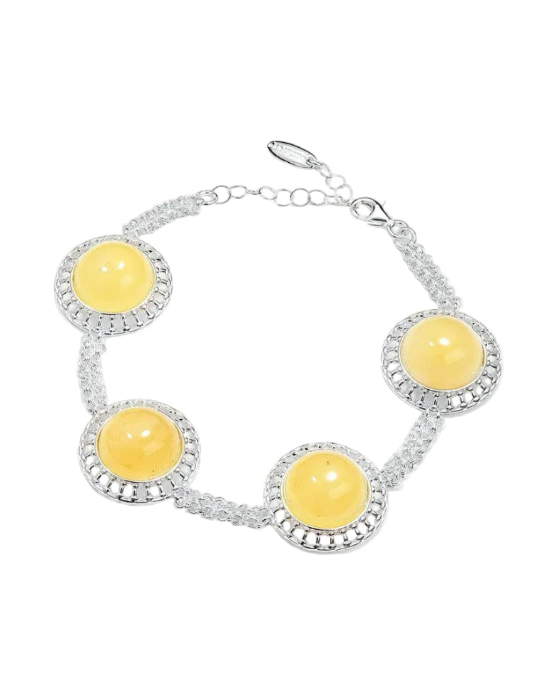 Bracelet with yellow circular stones and silver chain on a white background