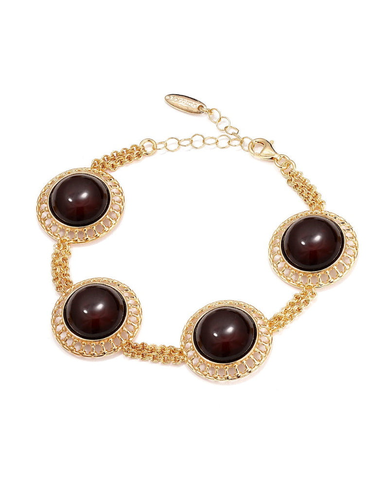 Gold bracelet with dark brown beads on a white background