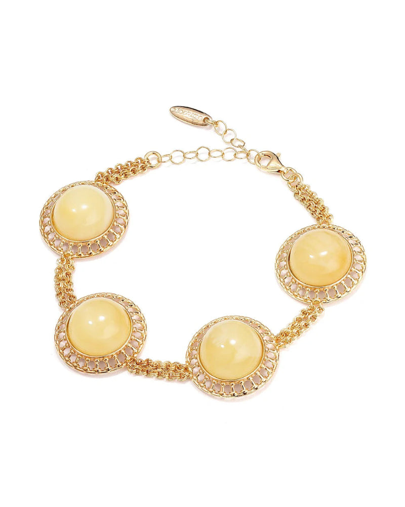 Gold bracelet with yellow beads on a white background